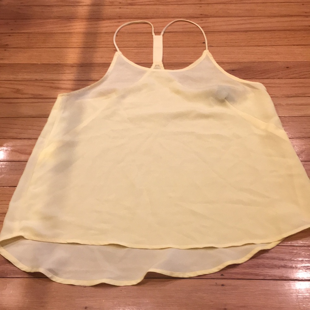 Yellow spaghetti strap shirt.